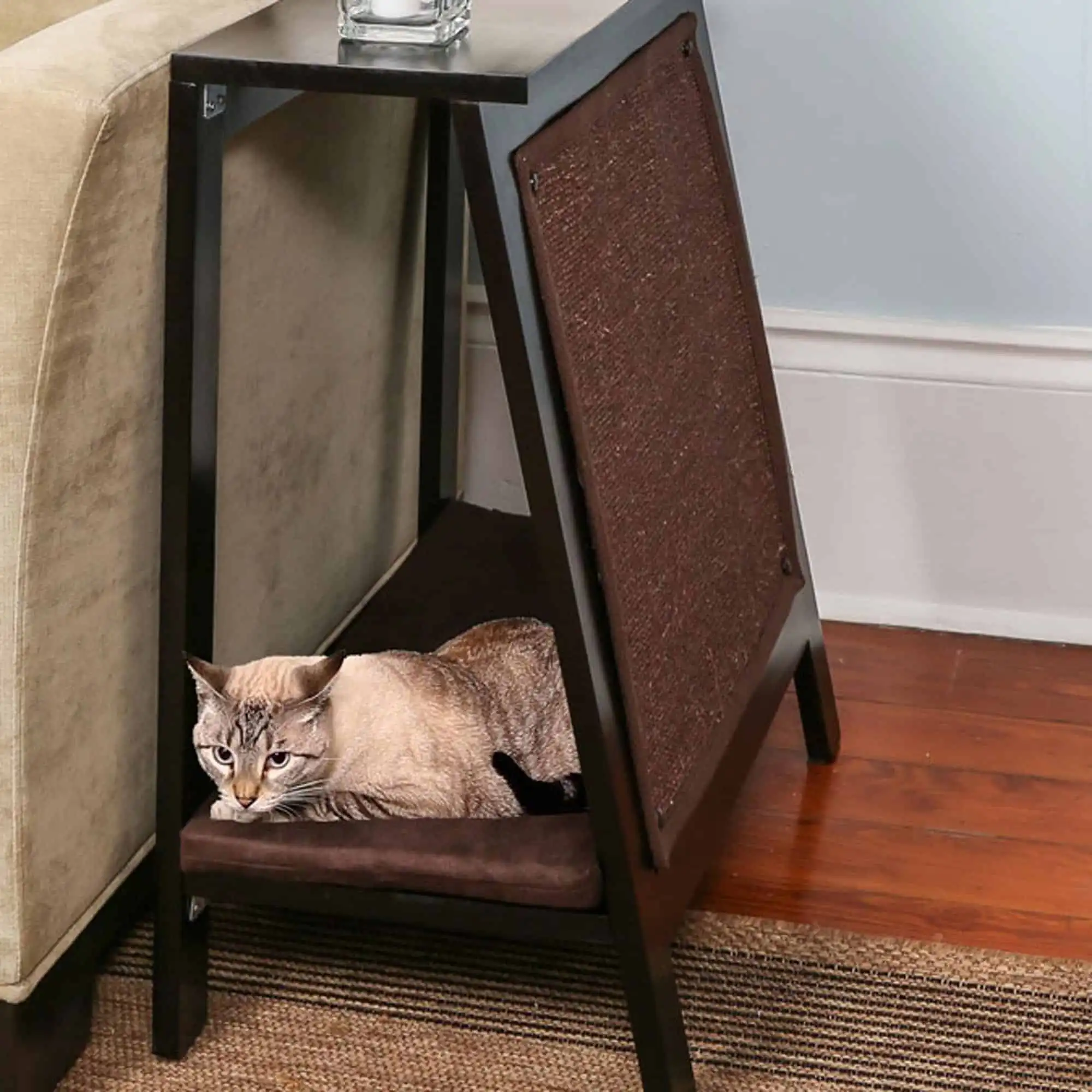 Cat lying on a modern A-Frame Cat Bed Espresso under a side table next to a sofa and textured rug.