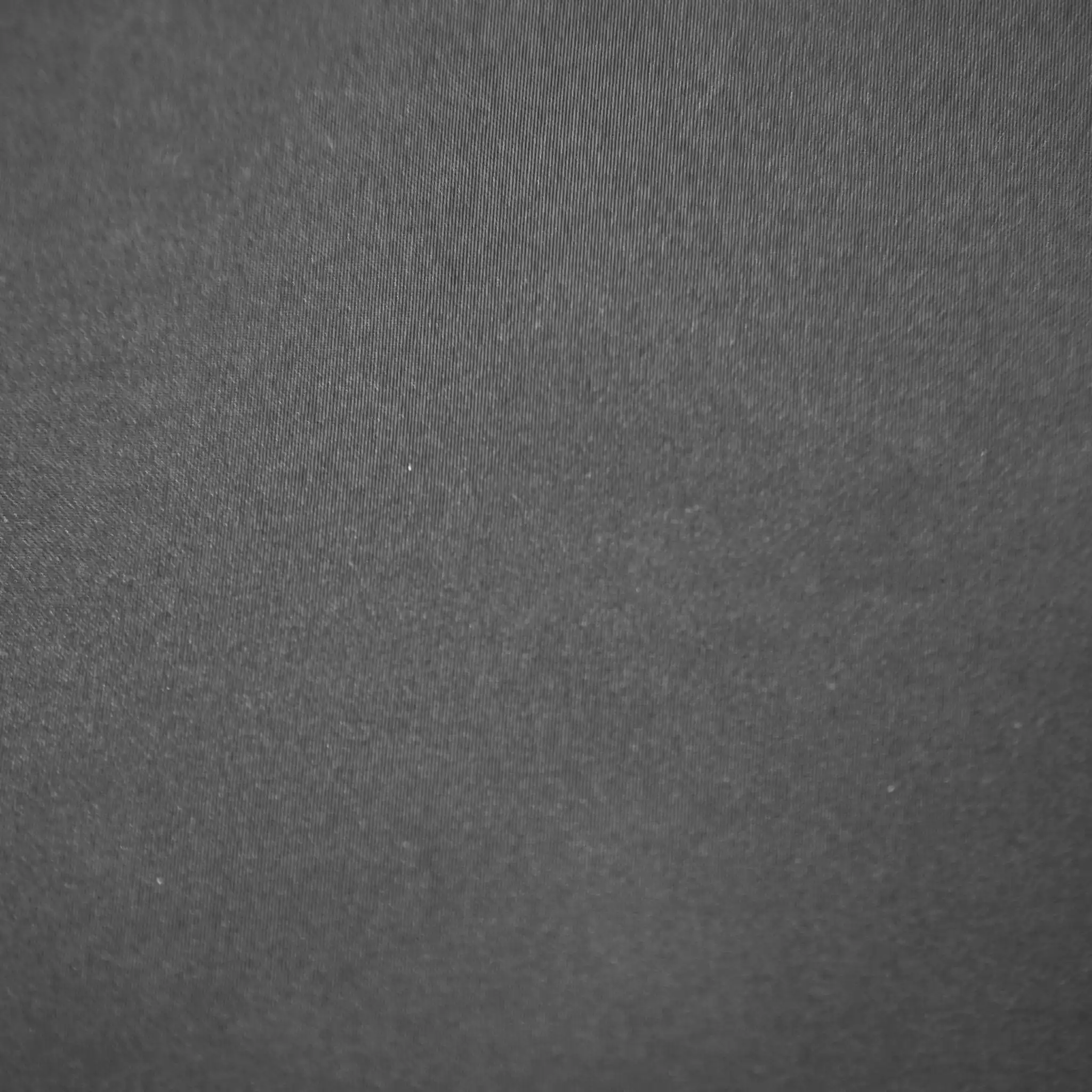 Close-up of dark grey Smoke fabric with a subtle visible texture and diagonal weave pattern.