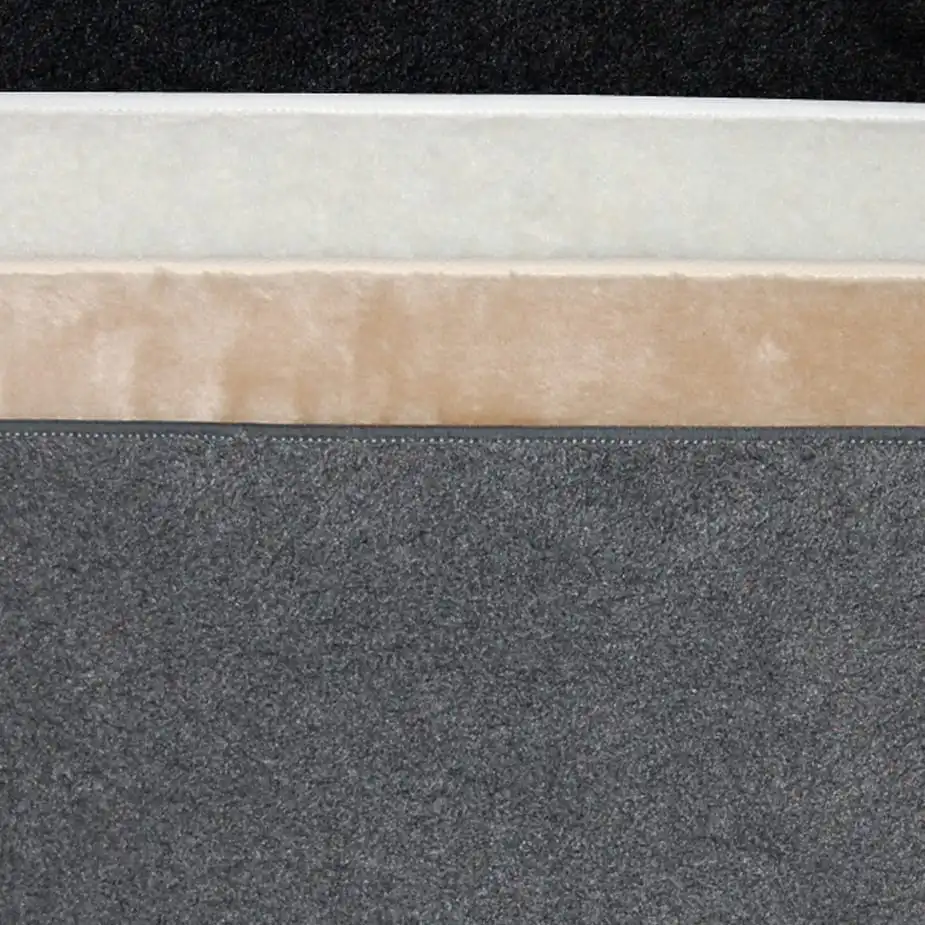 Four stacked layers in black, white, beige, and gray, each with distinct thickness and texture for cat comfort or decor.