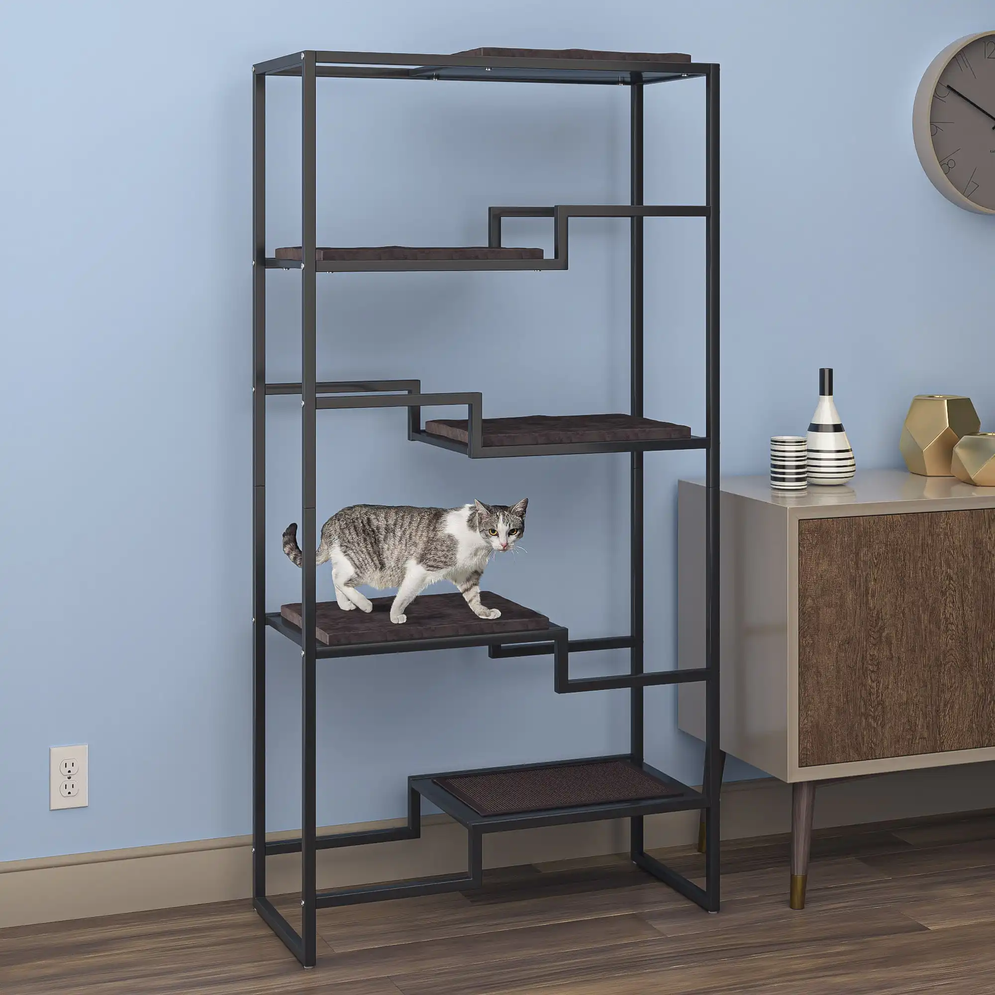 Cat on a black metal cat tower with brown cushion, in a minimalist room with light blue walls and mid-century decor.
