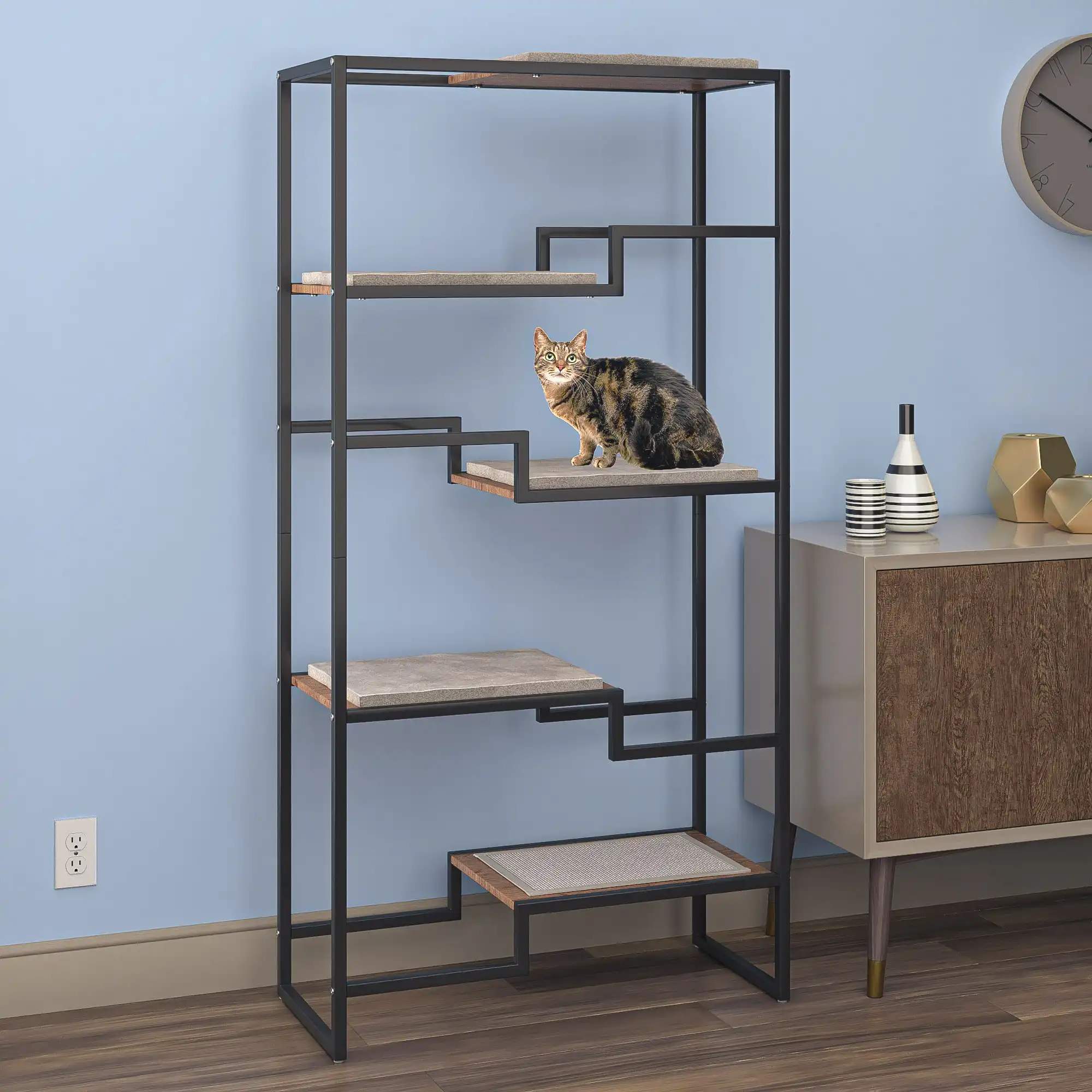 Cat lounging on brown platform of tall black metal cat condo in modern living room with light blue walls.