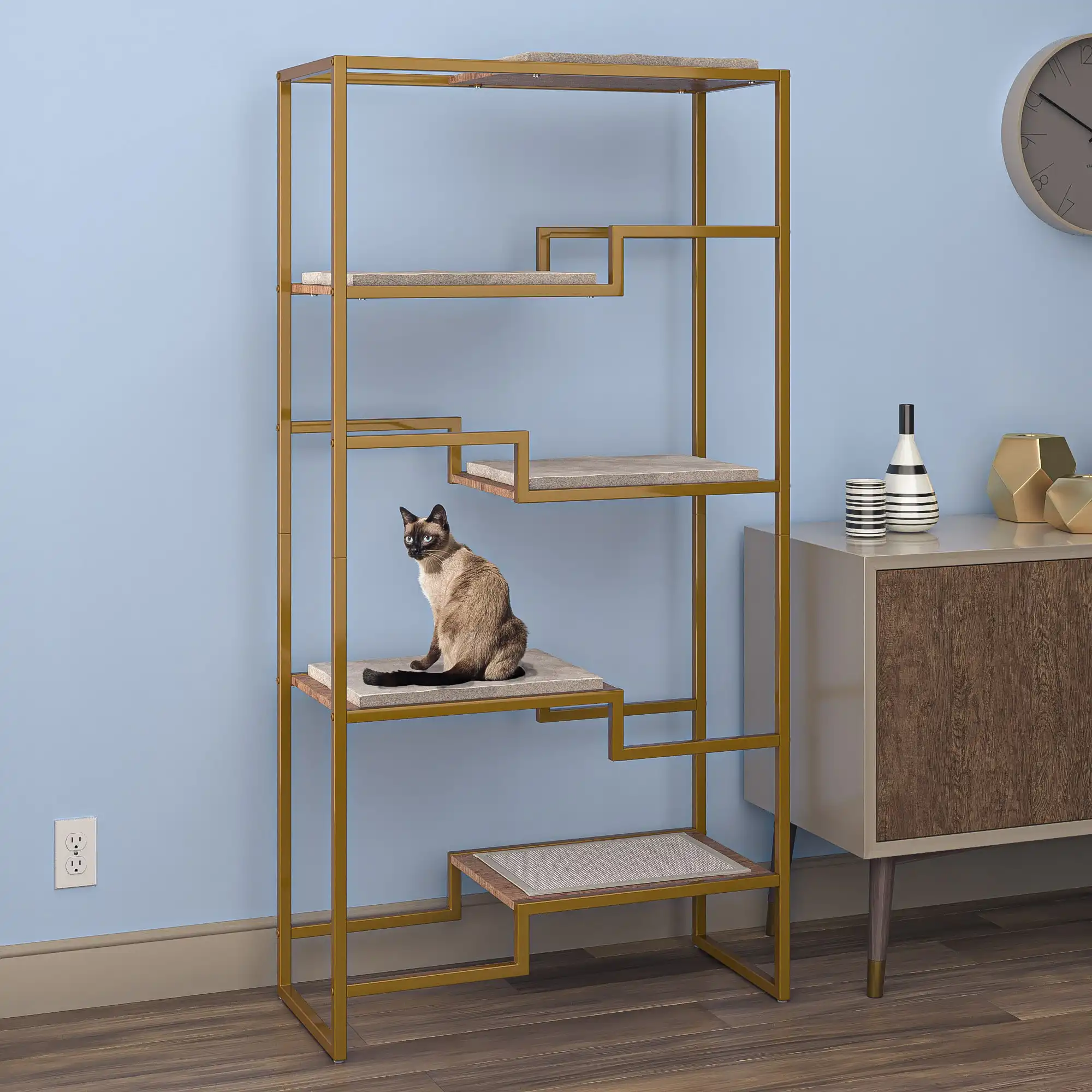 Cat on a modern gold condo with beige platforms, next to a wooden cabinet against a blue wall.
