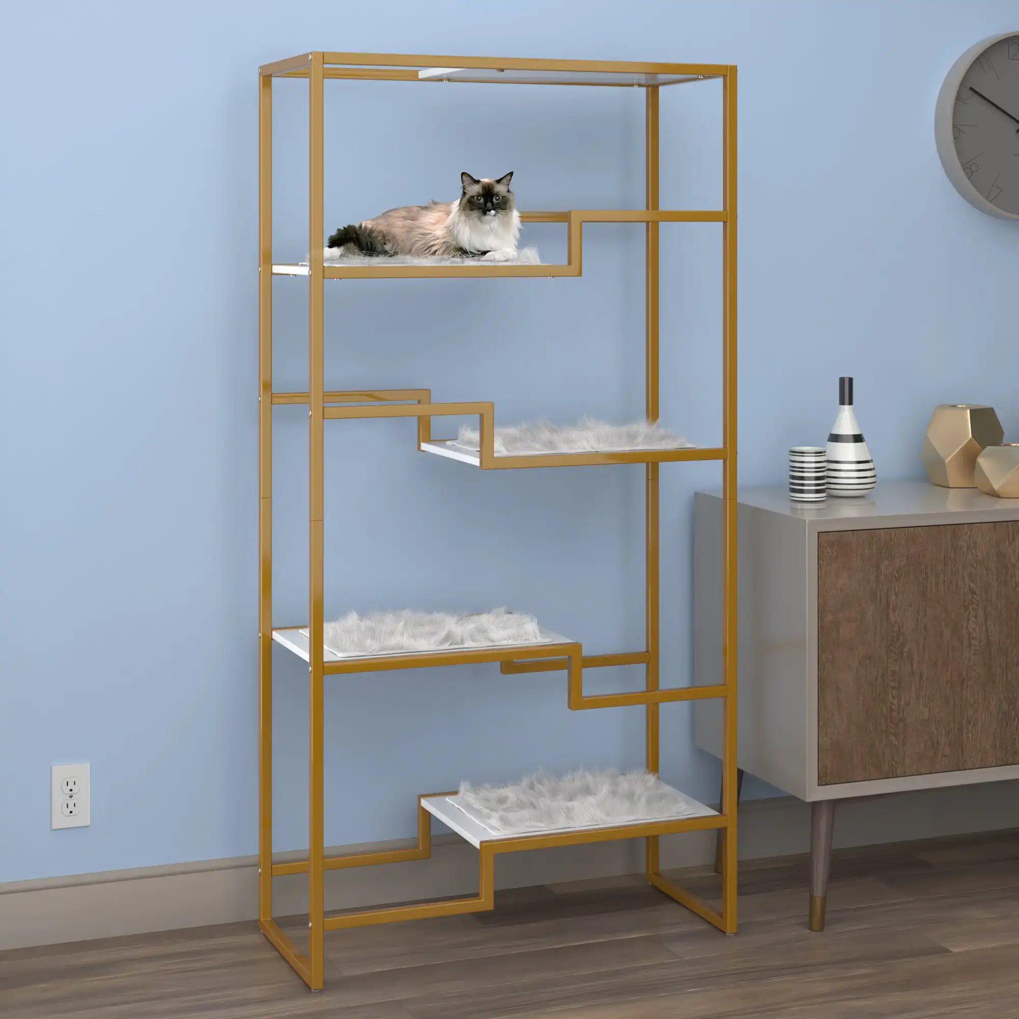 Cat resting on top tier of white cat condo next to wooden sideboard in modern room with blue walls.