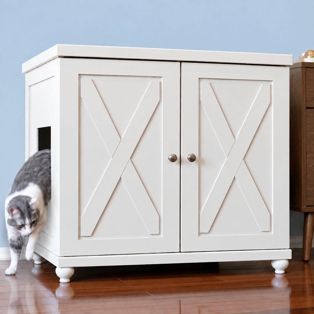 A gray and white cat steps out of a white, X-patterned ERLB-XL-WH-FARM-TULIP deluxe cat litter box.