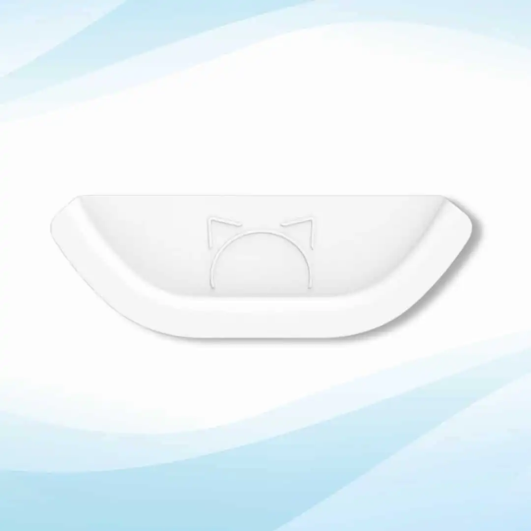 White curved litter box guard with embossed cat ears at center, set against a soft blue and white background.